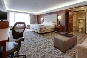 a hotel room with a bed and a living room at Drury Inn & Suites Overland Park in Overland Park +39 photos