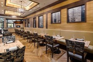 a dining room with tables and chairs and windows at The Whitehall Hotel - BW Premier Collection in Chicago