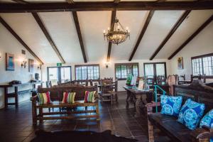 a room with chairs and tables and a chandelier at Hacienda de Leal - BW Signature Collection in San Juan Bautista