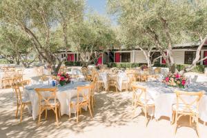 a wedding reception with white tables and chairs and flowers at Hacienda de Leal - BW Signature Collection in San Juan Bautista