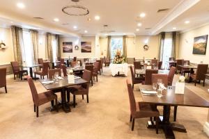 a restaurant with tables and chairs in a room at Crabwall Manor & Spa - BW Signature Collection in Chester