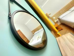 a mirror with a reflection of a bed in a room at Trebis in Naples