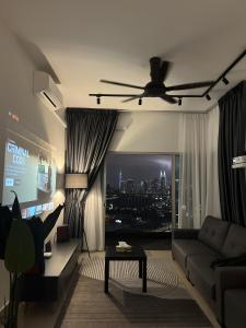 a living room with a couch and a ceiling fan at Lisa Homestay, KLCC View Homestay with Home Theatre in Kuala Lumpur