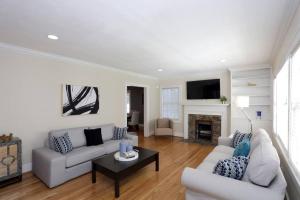 a living room with two couches and a fireplace at Gem in Midtown 4bedroom home-11 in Atlanta