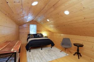 a bedroom in a log cabin with a bed and a chair at Gem in Midtown 4bedroom home-11 in Atlanta