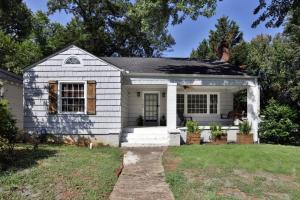 a small white house with a porch at Gem in Midtown 4bedroom home-11 in Atlanta