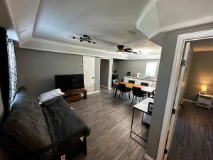 a living room with a couch and a dining room at Hess St in San Antonio