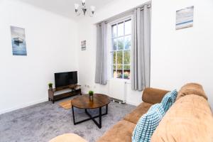 ein Wohnzimmer mit einem Sofa und einem TV in der Unterkunft May Disc - Long Stay - Contractors in Bristol
