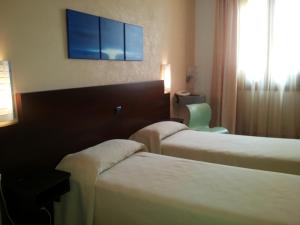 Posteľ alebo postele v izbe v ubytovaní Hotel Villa Ionia