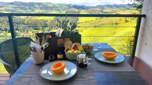 a table with two plates of oranges on a balcony at Pousada Casa Bambu in Cunha +49 photos