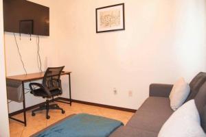 a living room with a couch and a desk at 3BD 2BT town suite minutes away Medical Center in Edinburg