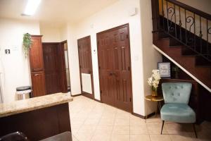 a hallway with stairs and a blue chair and a table at 3BD 2BT town suite minutes away Medical Center in Edinburg