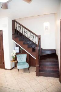 a room with a staircase and a blue chair at 3BD 2BT town suite minutes away Medical Center in Edinburg +4 photos