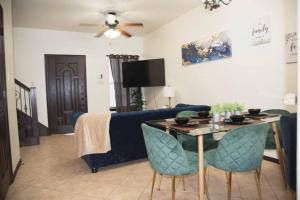 a living room with a blue couch and a table at Modern 2 bed 2-bath next to University UTRGV in Edinburg