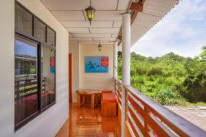 a porch with a table and a window at Hospedaje Germania in Puerto Ayora