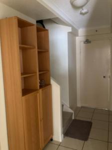 a room with a book shelf next to a door at Windsurfer Resort in Gold Coast