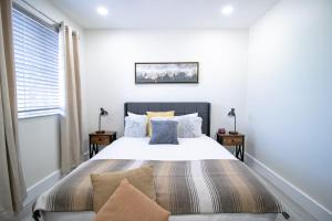 a bedroom with a large bed with pillows at Good Vibes Oasis - Cozy townhome with parking in Cutler Bay