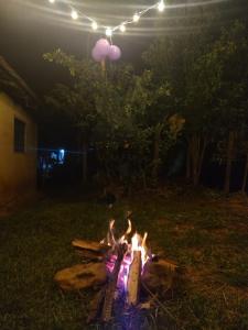 a fire pit in a yard at night with lights at Finca el recuerdo Arbelaence in Arbeláez