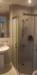 a bathroom with a shower and a sink at Penthouse at Poblacion - 200Mbs net - Awesome view in Manila