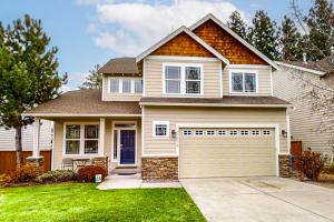 a house with a garage in a yard at Around the Bend in Bend