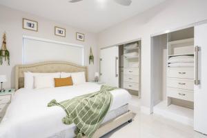 a white bedroom with a large bed and white cabinets at New Miami & Calle Ocho Home with Arcade! in Miami