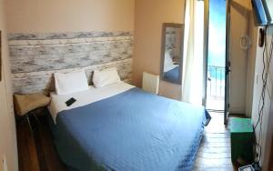 een slaapkamer met een blauw bed en een bakstenen muur bij Hotel Nativo in Santiago