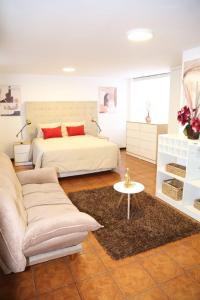 a bedroom with a bed and a couch and a table at Hoteles Riviera Ejecutivo in Arequipa