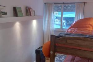 a bedroom with a bed and a window with a view at Torre Libertador in Buenos Aires