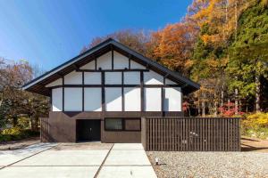 a house with a large window and a garage at SOMA RESIDENCE HAKUBA in Hakuba