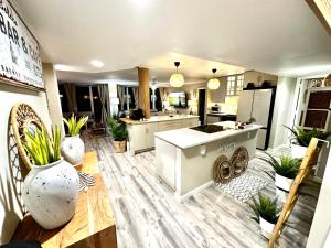 a kitchen and dining room with a table and a counter at Beach Oasis 601 Gorgeous Ocean front Ocean view for 10 sleeps up to 15 in Daytona Beach +59 photos