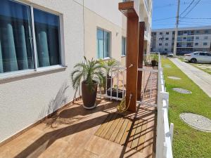 a porch of a house with a potted plant at Ap Grão de Areia - Praia dos Milionários Ilhéus-BA in Ilhéus