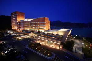 a large building at night with a parking lot at Geoje Samsung Hotel in Geoje