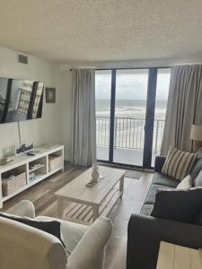 a living room with a view of the ocean at 1 Bedroom -1 Bath Ocean View Condo At Ocean Trillium 802 in New Smyrna Beach