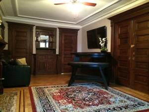 a living room with a piano and a rug at Garden Apartment with Private Entry in Brooklyn