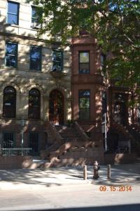 a building with a fire hydrant in front of it at Garden Apartment with Private Entry in Brooklyn