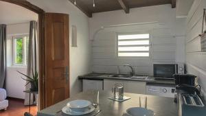 a kitchen with a sink and a counter top at Bungalow cosy près des plages in Le Gosier