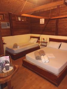 a bedroom with two beds and a tub in it at Chalé Ebenézer in Eldorado