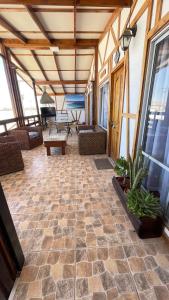 a screened in porch with a stone floor and windows at CABAÑA VIP in Caldera