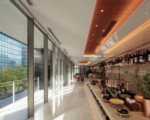 a large glass building with a wine store at Candeo Hotels Osaka Shinsaibashi in Osaka