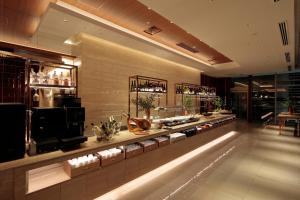 a store with a counter with a lot of products at Candeo Hotels Osaka Shinsaibashi in Osaka