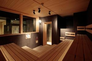 a room with a wooden floor and a clock on the wall at Candeo Hotels Osaka Shinsaibashi in Osaka