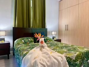 a bedroom with a bed with a dress on it at Fare To'erau - New cozy vacation home on Bora Bora in Bora Bora