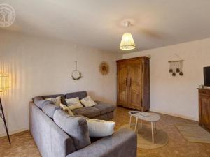 a living room with a couch and a table at Gîte Chalmazel-Jeansagnière, 6 pièces, 12 personnes - FR-1-496-249 in Chalmazel Jeansagniere