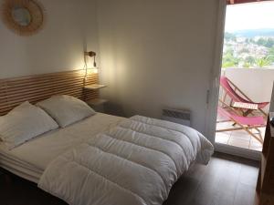 a bedroom with a bed and a large window at Appartement Hendaye, 2 pièces, 4 personnes - FR-1-239-777 in Hendaye