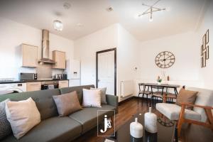 a living room with a couch and a kitchen at The Port Solent City Apartment - Southampton, Portsmouth in Southampton