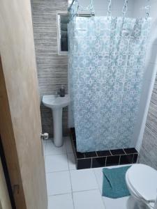 a bathroom with a shower curtain and a sink at Parcela fuentes in Cartagena