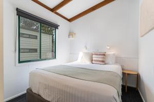a bedroom with a bed and a window at Tasman Holiday Parks - Geelong in Geelong