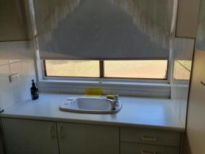 a sink in a kitchen with a window at Three bedroom double lounge large house, sleeps 6 