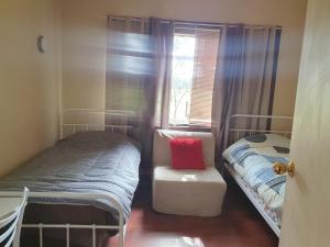 a small bedroom with two twin beds and a window at Three bedroom double lounge large house, sleeps 6 