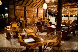 a room with tables and chairs in a building at Rinjani Lighthouse in Senaru +37 photos